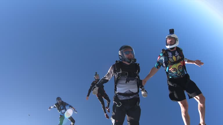 Group of skydivers parachuting / skydiving on sunny day