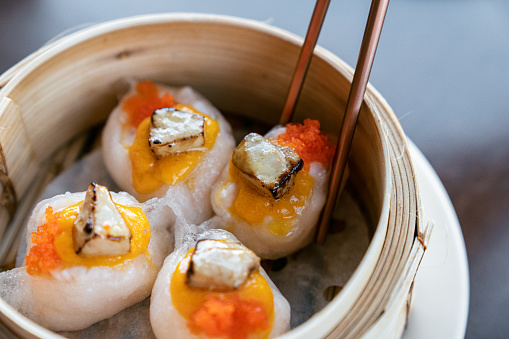 Special shrimps dim sum with chopsticks in bamboo steamer