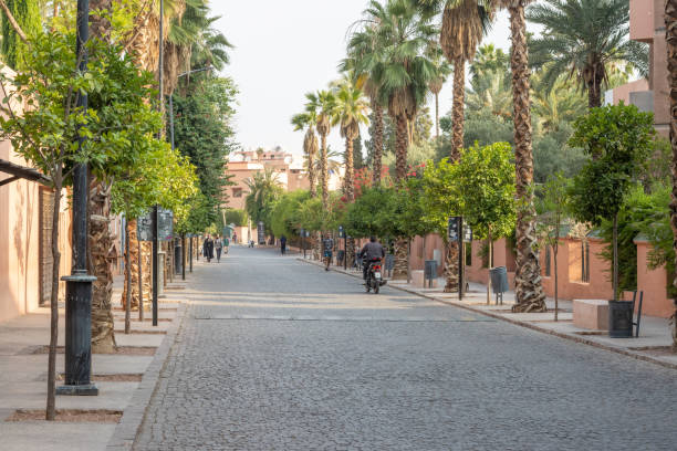 Rue Yves St Laurent in Marrakesh at Marrakesh-Safi, Morocco People in the distance on the Rue Yves St Laurent in Marrakesh at Marrakesh-Safi, Morocco, outside the Majorelle Gardens. marrakesh safi photos stock pictures, royalty-free photos & images