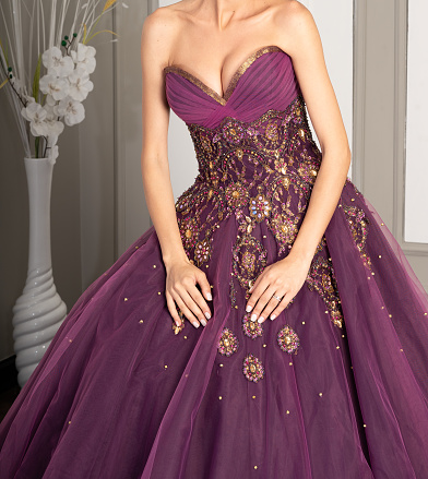 sexy women is in purple evening dress hands are on skirt fashion still