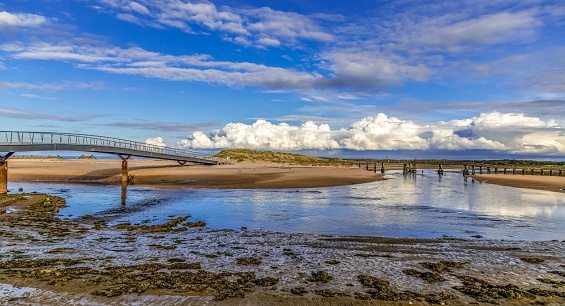 An awe-inspiring view of a coastal landscape featuring two bridges spanning across a tranquil body of water