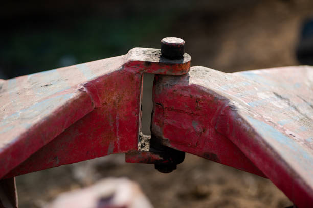 A closeup view of the coupling on a disc harrow for cultivating land