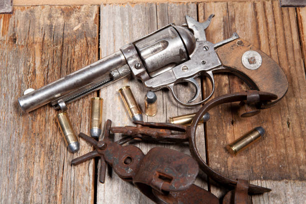 istock An old .44 caliber revolver with rusty spurs, on a wooden background. 1498091268