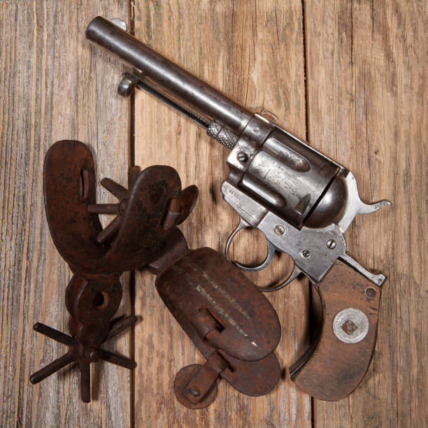 istock An old .44 caliber revolver with rusty spurs, on a wooden background. 1498091294