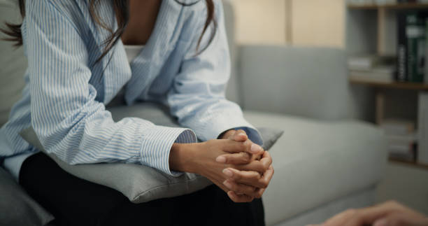 istock Psychologist supporting a young woman suffering from depression while sitting on the couch 1498092791