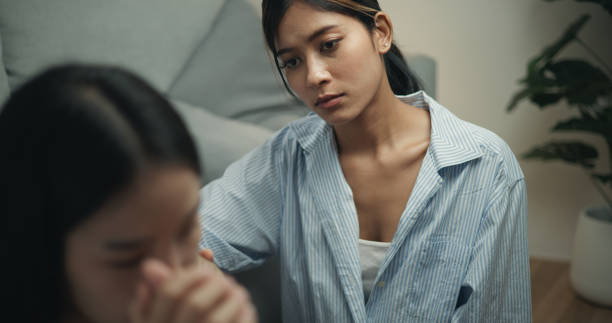 istock Psychologist supporting a young woman suffering from depression while sitting on the couch 1498092886