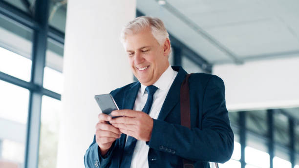 istock Businessman, phone or walking while reading email, contact or networking in the morning in a office. Senior corporate worker check schedule with online app, 5g mobile or smartphone for communication 1498096895