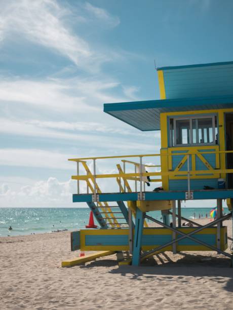istock Vibrant lifeguard tower on a beach with pristine white sand stretching out to a calm blue ocean 1498097087