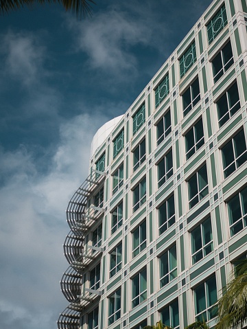 A majestic white building features numerous windows providing an impressive and timeless silhouette