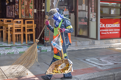 Bangkok, Thailand - March 24th 2023: Street sweeper working with professional equipment  in the center of the capital of Thailand