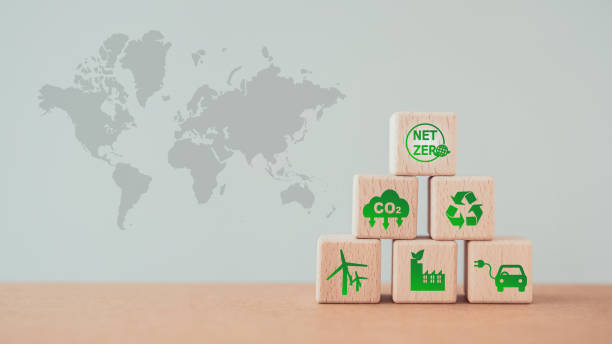 istock Carbon neutral and net zero concept natural environment Climate-neutral long-term strategy greenhouse gas emissions targets . Stack of wooden cube block with green net zero icon on top and world map 1498100434