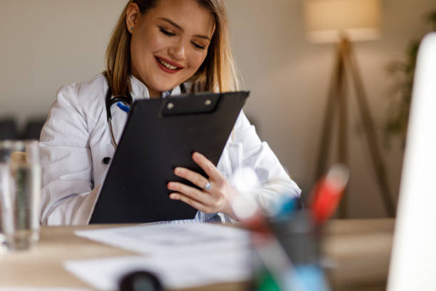 istock Professional nutritionist sitting at her desk and writing on a clipboard 1498101287