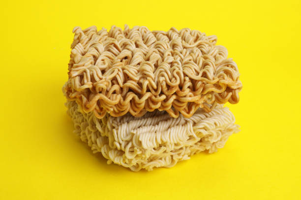 istock Dry instant noodles vermicelli on yellow background 1498103659