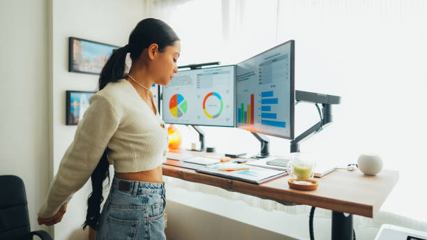 istock Woman at standing desk is working at home 1498104019