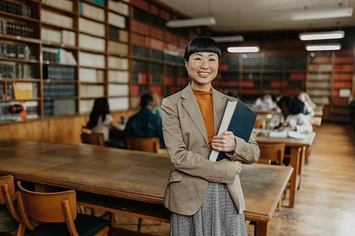 Portrait of the mid adult Japanese female professor in the university library