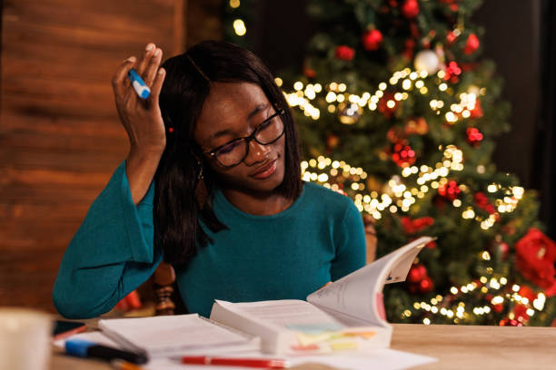 istock Diligent young woman studying at home office during Christmas holidays 1498105401