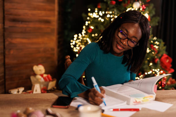 istock Young woman sitting at home office desk, highlighting notes while studying for exam 1498105620