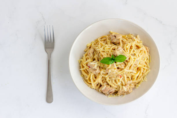 istock Cheesy Chicken Pasta Garnished with Basil Directly Above Photo 1498105649