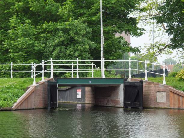 istock a boat passes under a bridge on a small lake, 1498105775