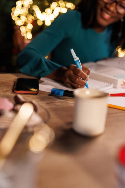 istock Young woman sitting at home office desk, highlighting notes while studying for exam 1498105897