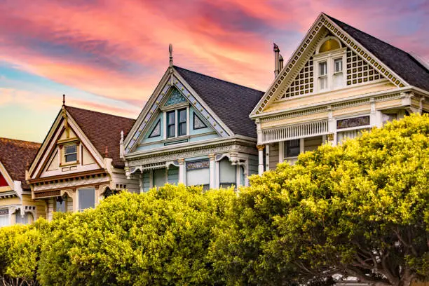 Photo of Photograph of the Painted Ladies of San Francisco in the state of California, USA. Californian Victorian houses of USA under an orange sky at sunset.