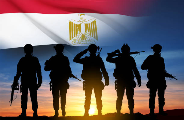 istock Silhouettes of soldiers against the sunset with Egypt flag 1498107535
