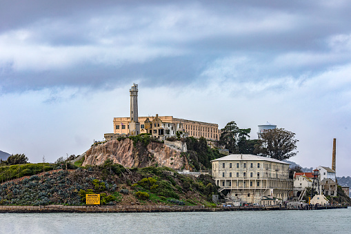 Photograph of the federal prison of Alcatraz on its island in the middle of the San Francisco Bay in California, USA. Prison of the United States of America of maximum security. Prison concept.