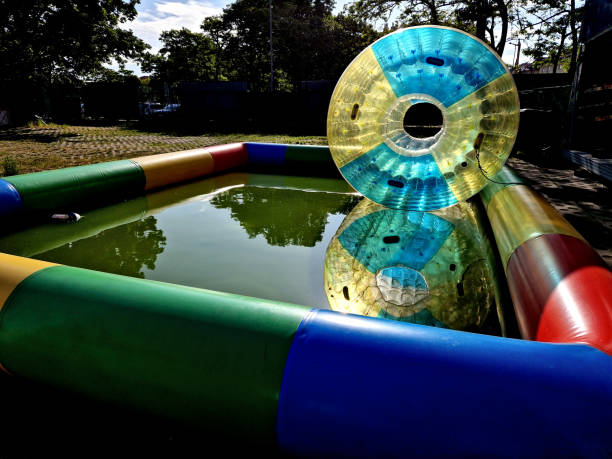 activity  Park is Water Zorbing. Enjoy aquatic life as you struggle in bubble! These water walkers are ultimate challenge, try to see if you can stand upright or run activity  Park is Water Zorbing. Enjoy aquatic life as you struggle in bubble! These water walkers are ultimate challenge, try to see if you can stand upright or run , attraction, water balloon, fitness, waterball, roller, scrolls, zorbing zorb ball stock pictures, royalty-free photos & images
