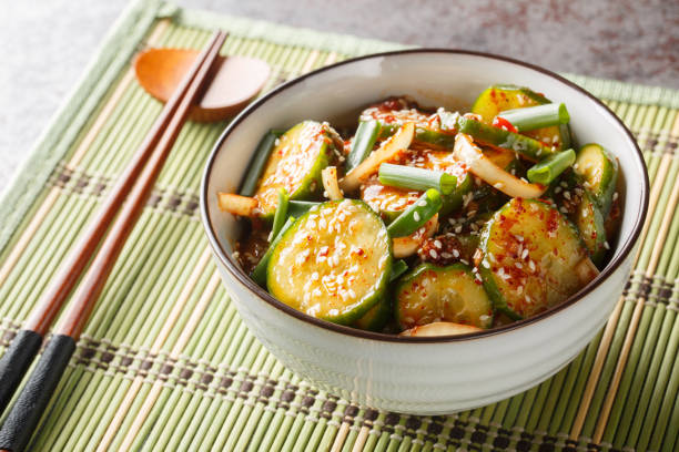 Easy Spicy Korean Cucumber Salad Oi Muchim made with garlic, onion, sesame and hot peppers. Horizontal stock photo