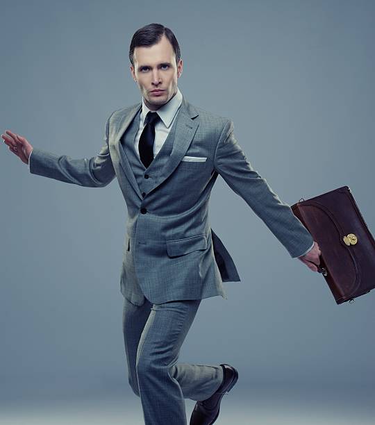 istock Businessman with a briefcase isolated on grey 149811411