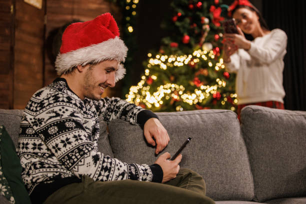 istock Couple spending Christmas holidays relaxing and using their smart phones. 1498114774