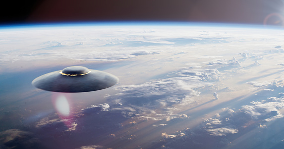 Hovering above the Earth, a UFO defies the laws of gravity, its presence captivating and enigmatic. The unidentified flying object casts a mesmerizing glow against the backdrop of our planet, drawing attention to its extraordinary nature.