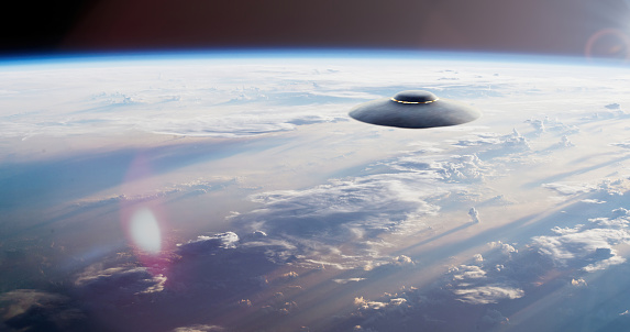 Floating in the sky, a UFO breaks the rules of gravity, capturing everyone's attention with its mysterious and puzzling appearance. The strange flying object emits a fascinating light against the Earth's background, making it even more extraordinary and intriguing.