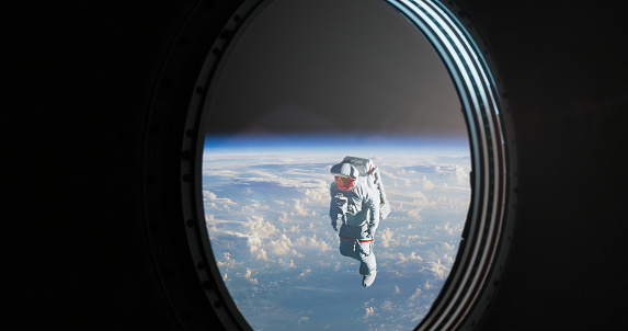 Through the spacecraft's porthole, an awe-inspiring sight awaits as an astronaut floats gracefully in the depths of space. The window, meticulously crafted for celestial exploration, provides a view of the intrepid explorer adorned in a spacesuit, seemingly weightless and suspended in the vast expanse.