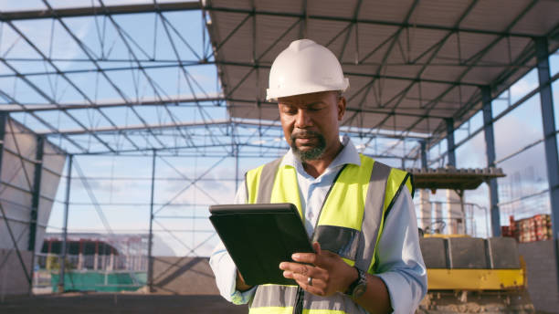 istock Man, construction and tablet at site for project management, building logistics or app. Male person and engineering worker on digital technology at industrial architecture design 1498117177
