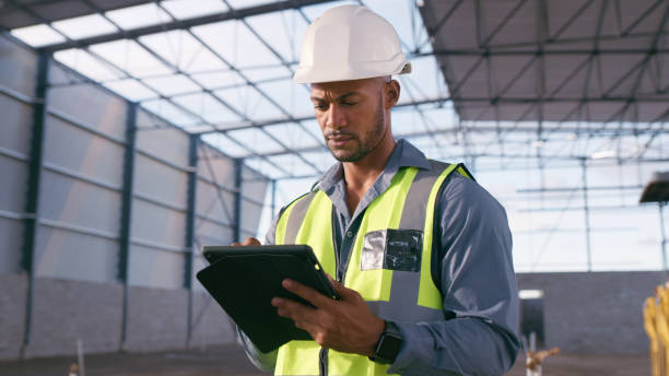 istock Man, construction and tablet at site for project management, building logistics or app. Male person and engineering worker on digital technology at industrial architecture design 1498117179