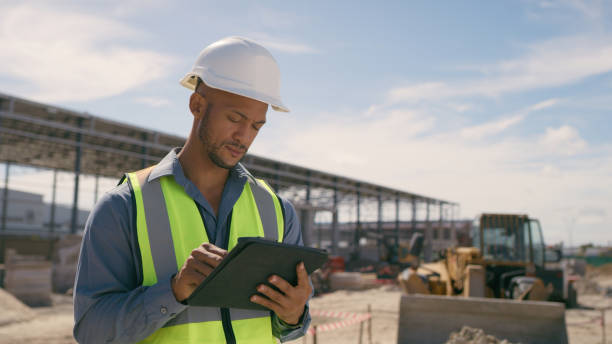 istock Man, construction and tablet at site for project management, building logistics or app. Male person and engineering worker on digital technology at industrial architecture design 1498117220