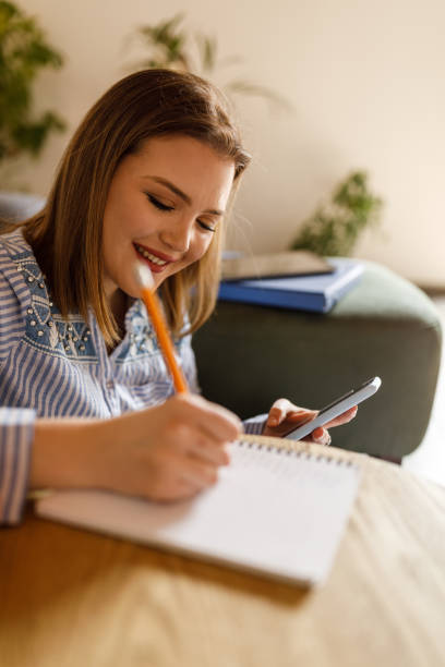 istock Young female student writing research and studying about nutrition 1498118279