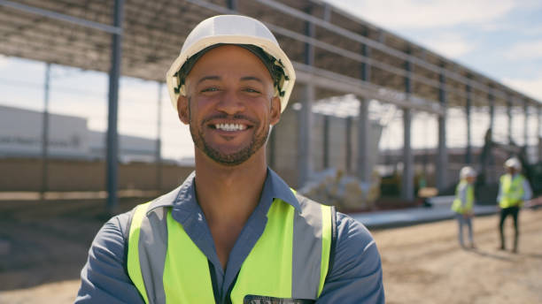 istock Happy man, construction and face for engineering, project management and labor. Portrait, smile and male builder at building site for property development or infrastructure 1498118434