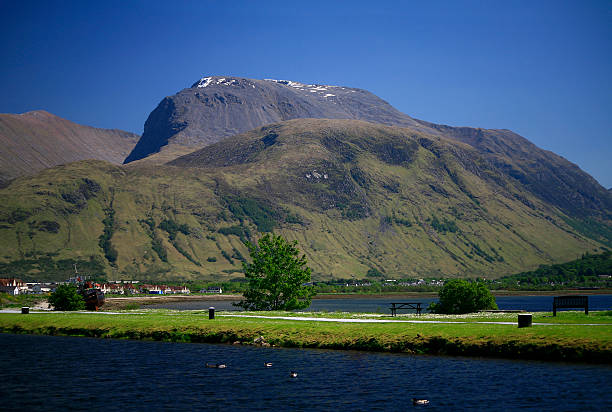 Ben Nevis from Corpach, Lochaber, Scotland Ben Nevis is the highest mountain in Britain - 1,344 metres (4,406 ft) above sea level and is located in the Lochaber area of Scotland. The Caledonial canal can be seen in the foreground, beyond is Loch Linnhe and part of the town of Fort William lochaber stock pictures, royalty-free photos & images