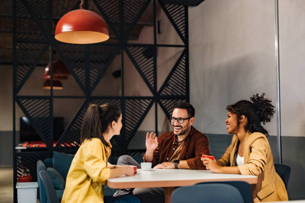 istock Business team gathering around the table during coffee time, talking about work. 1498120336