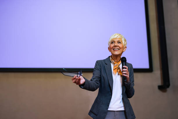 istock A smiling woman giving a speech at the conference, elegantly dressed. 1498120348
