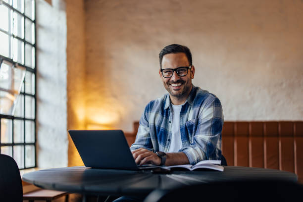 istock Portrait of a man, using a laptop while posing for the camera. 1498120694