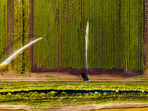 Aerial view of agricultural sprinklers watering field for better growth
