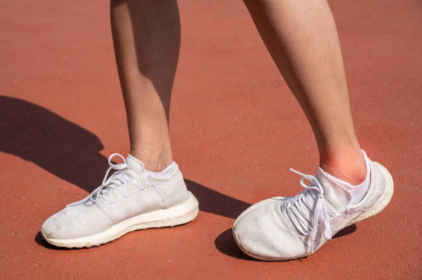 istock Close up of female runner legs having an ankle sprain problem after workout. 1498121589