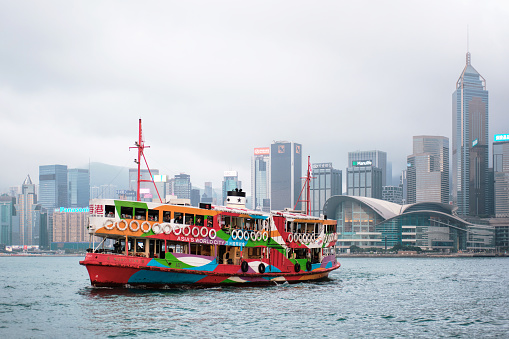 Hong Kong, China - April 18, 2023: View of a colorful ferry and skyline of Victoria Harbour