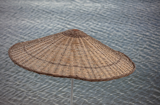 Straw beach umbrellas on the beach.