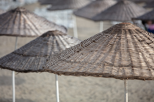 Straw beach umbrellas on the beach.