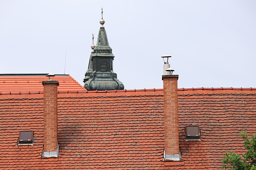 Roof and chimney from an old house - brick and metallic texture.