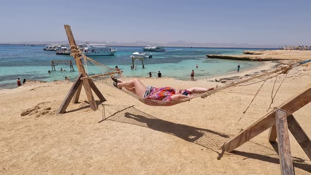 Young Woman Lying In A Hammock On The Paradise Island In Egypt